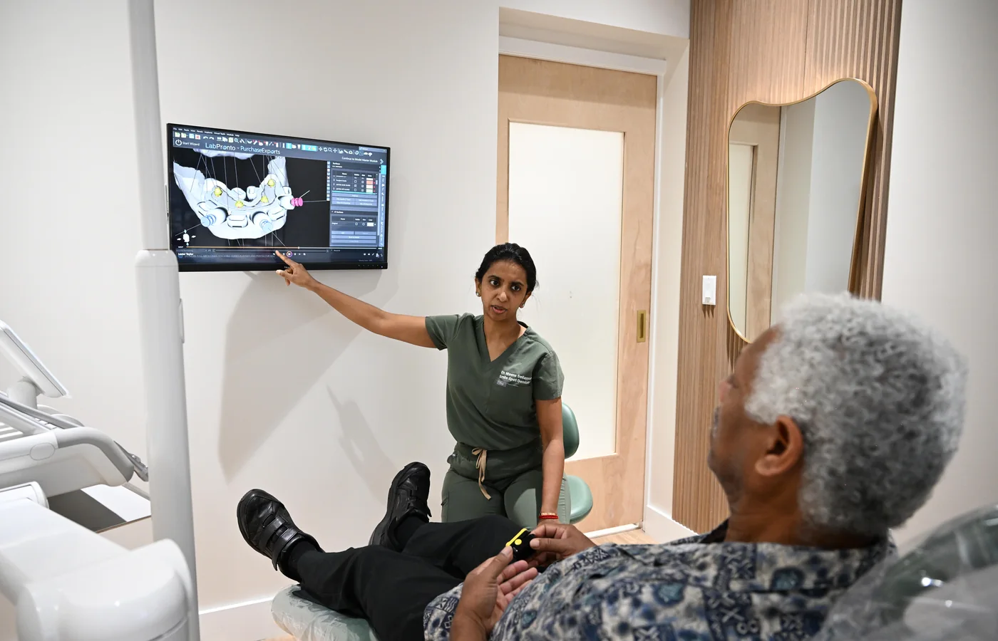 Dr. Sellappan reviewing a 3D CBCT scan with a patient at Smile Spot Dentistry, Venice, Florida
