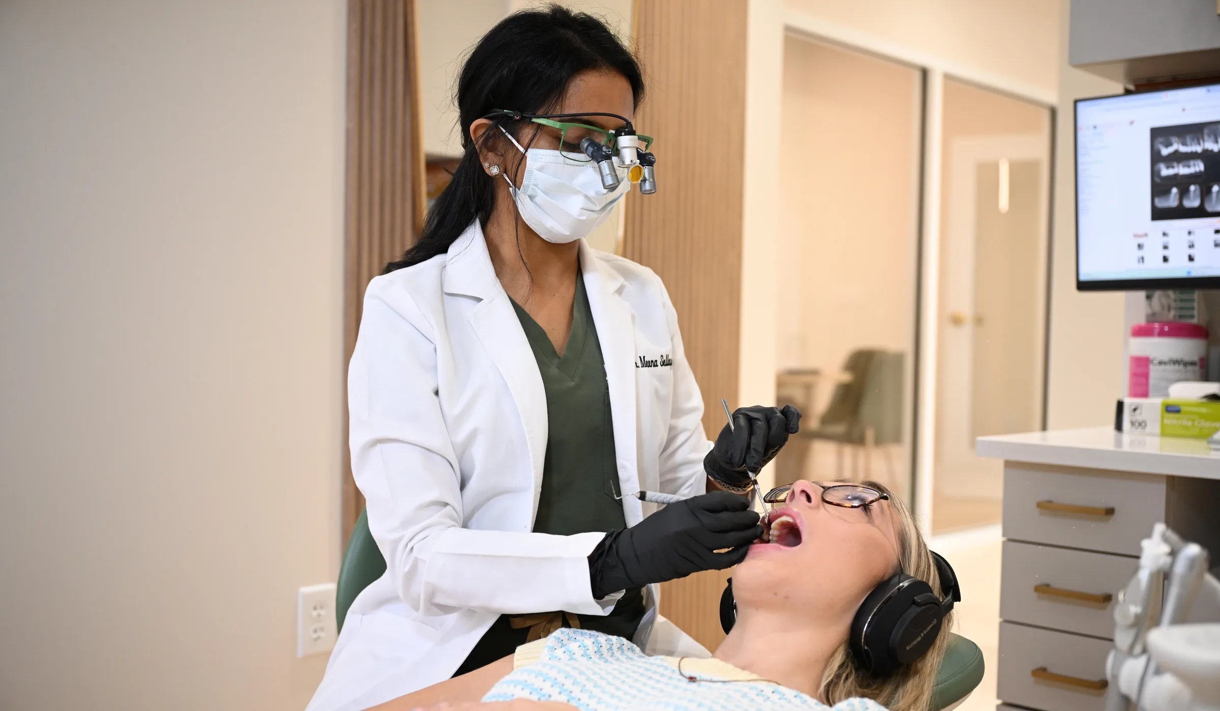 Dr. Meenachi Sellappan performing a same-day emergency dental exam at Smile Spot Dentistry, Venice, Florida