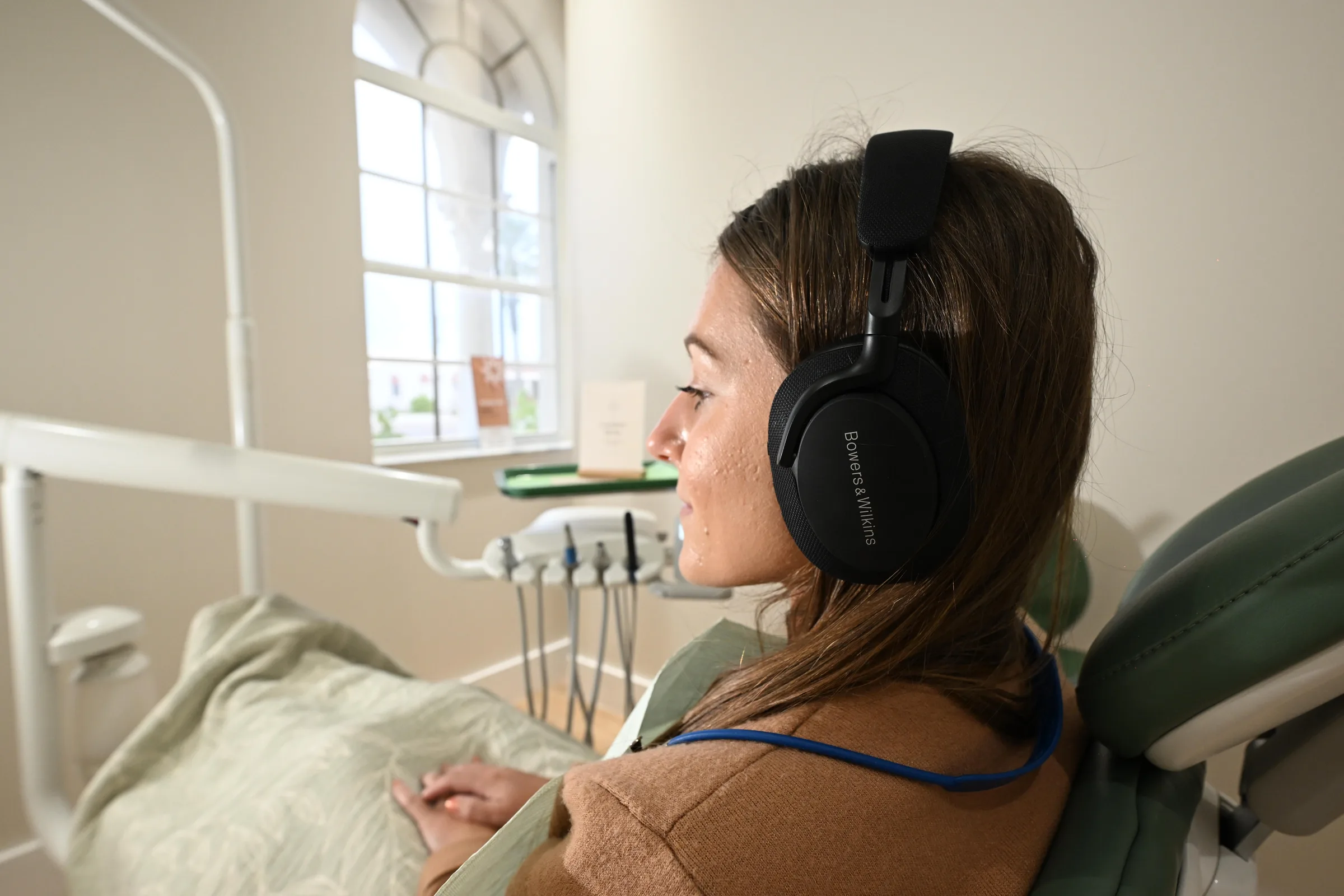 Patient relaxing with headphones and a blanket in the Sanctuary treatment room at Smile Spot Dentistry