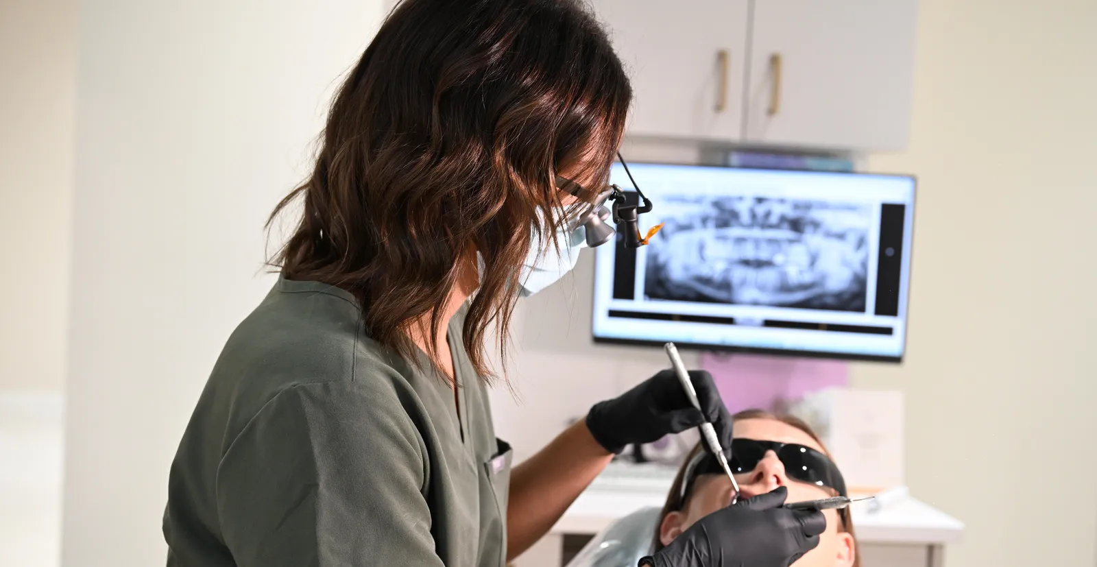 Examination — hygienist evaluating teeth and gums, images on screen — Smile Spot Dentistry, Venice FL