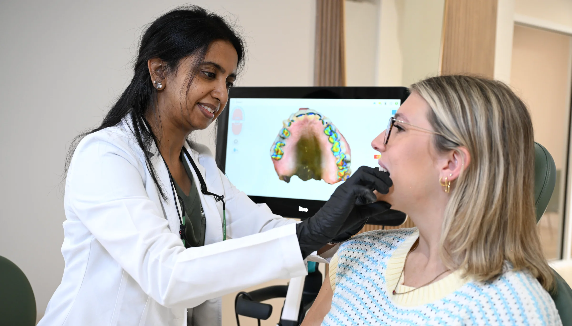 Dr. Meenachi Sellappan reviewing a patient's bite on an iTero 3D scan at Smile Spot Dentistry, Venice FL