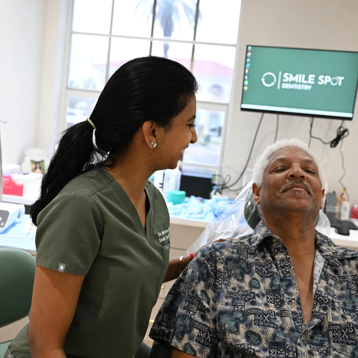 Dr. Sellappan sharing a laugh with a relaxed patient before treatment at Smile Spot Dentistry, Venice, Florida